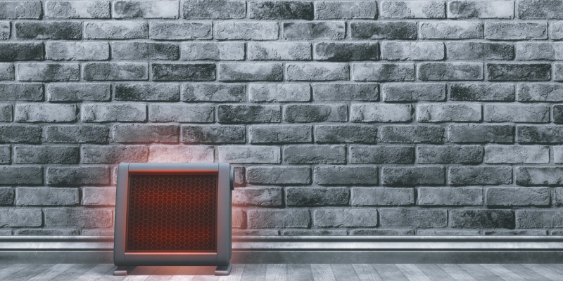 space heater in room with brick wall